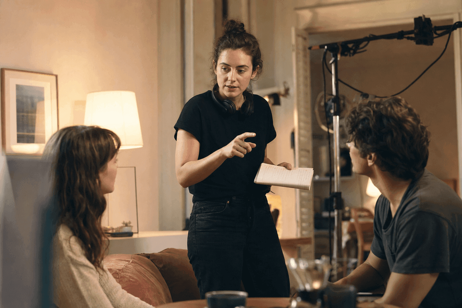 Filmmaker directing actors on set using prompt-driven creative direction